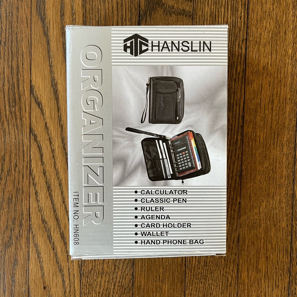 All in one organizer in black zip closure with multiple functions.